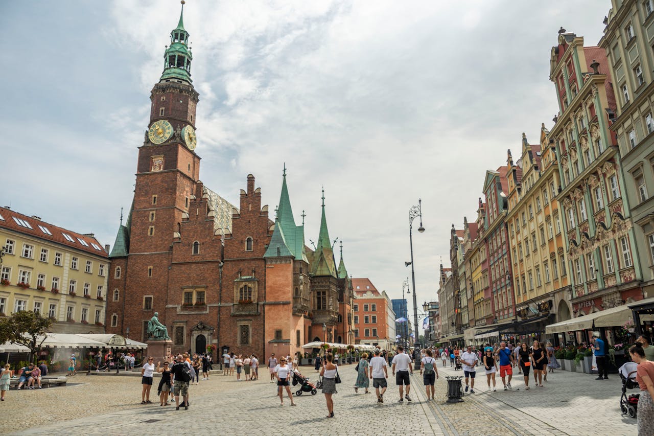 The Art of Drawing Readers In: Your attractive post title goes here Vibrant city square in Wrocław with historic architecture and bustling city life.